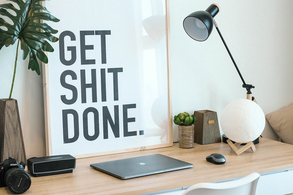 A work from home office space with a desk, lamp, and camera